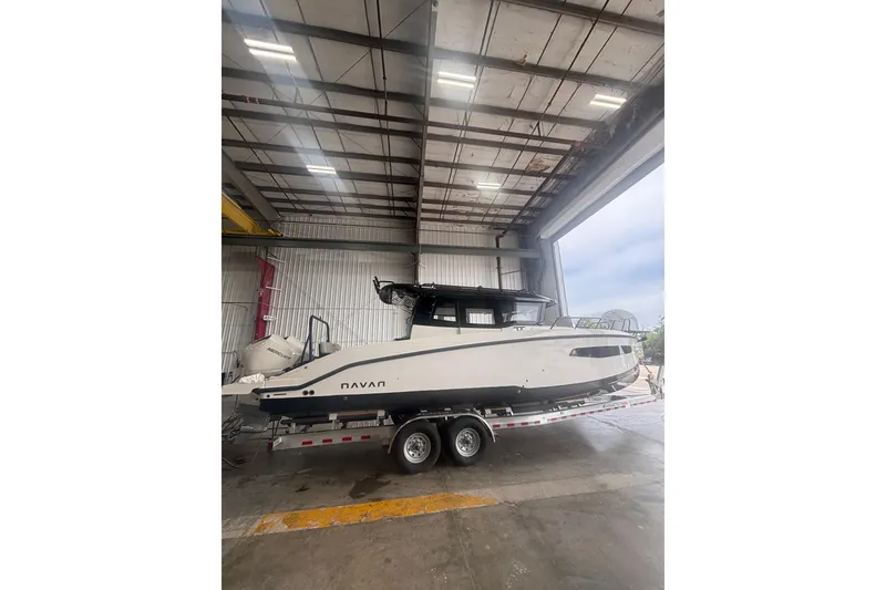 Slide: The Image of 2026 Navan C30 boat on trailer inside a large warehouse. - 4