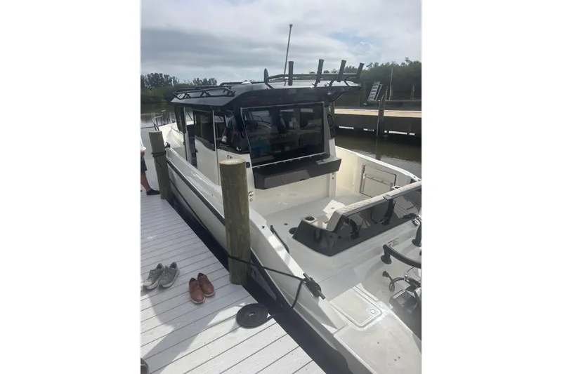 Slide: The Image of 2026 Navan C30 boat docked, featuring sleek design and spacious deck area. - 6