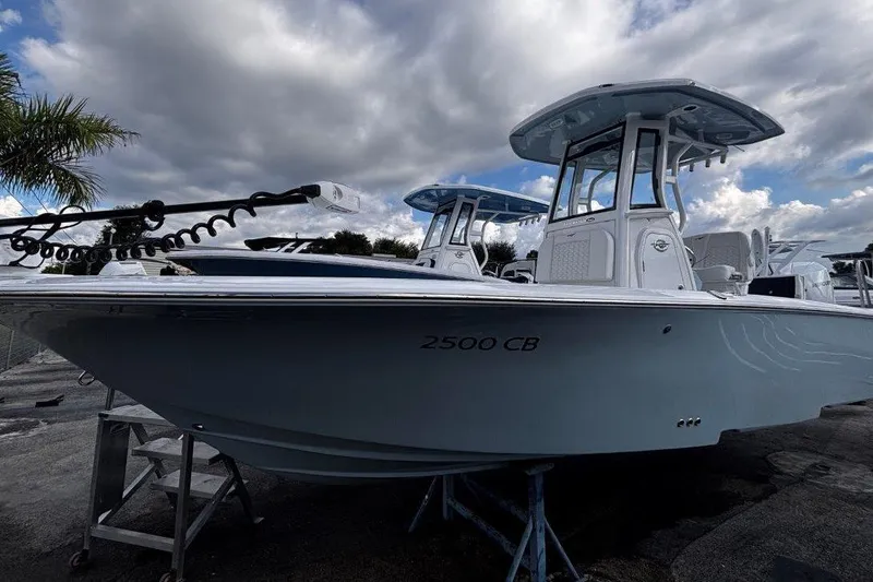 The Image of 2026 Tidewater 2500 Carolina Bay boat under cloudy sky, docked on a stand. - 1