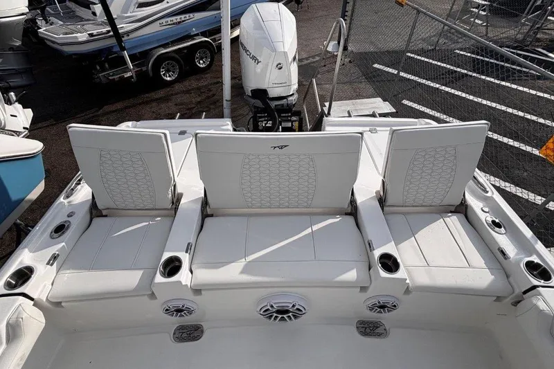 Slide: The Image of 2026 Tidewater 2500 Carolina Bay boat with white seating and Mercury outboard motor. - 13