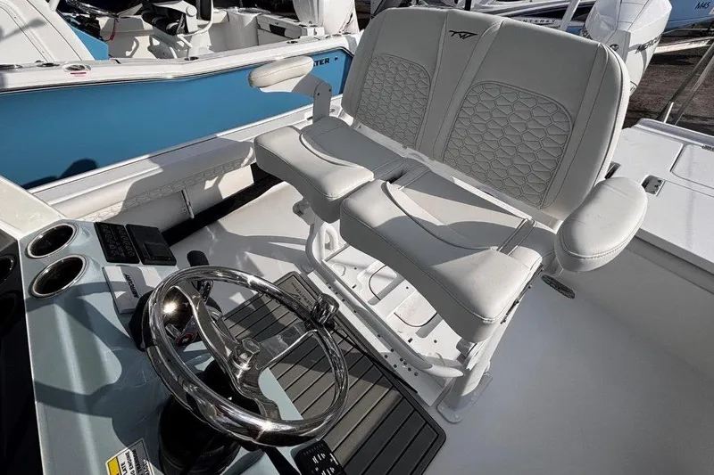 Slide: The Image of 2026 Tidewater 2500 Carolina Bay boat interior with dual seats and steering wheel. - 18