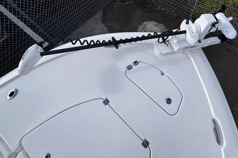 Slide: The Image of 2026 Tidewater 2500 Carolina Bay boat deck with trolling motor and storage hatches. - 34