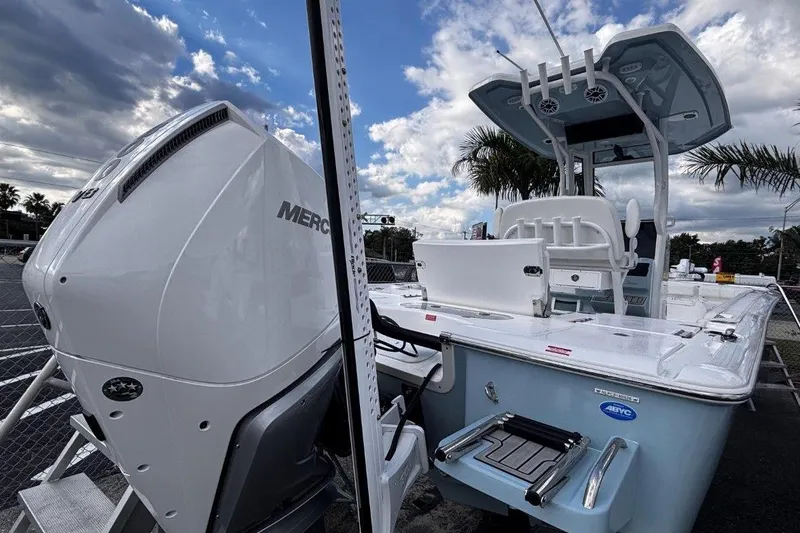 Slide: The Image of 2026 Tidewater 2500 Carolina Bay boat with Mercury engine, docked under cloudy sky. - 6