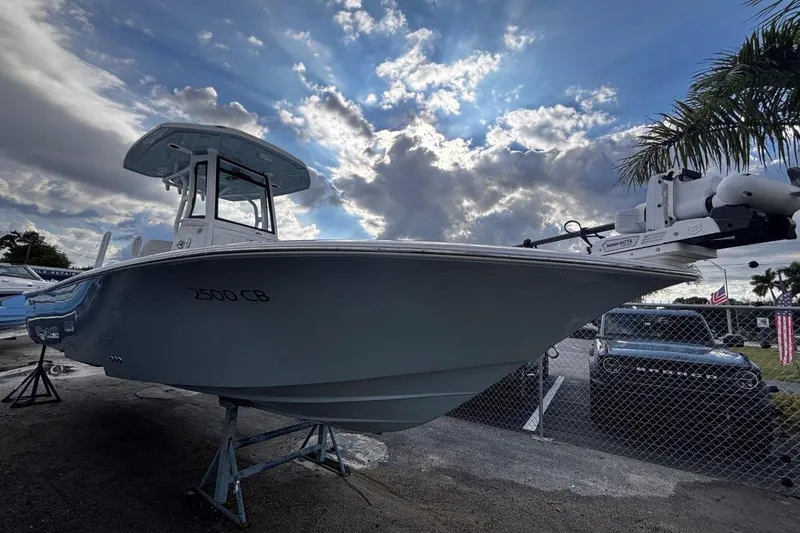 Slide: The Image of 2026 Tidewater 2500 Carolina Bay boat displayed under dramatic cloudy sky. - 9