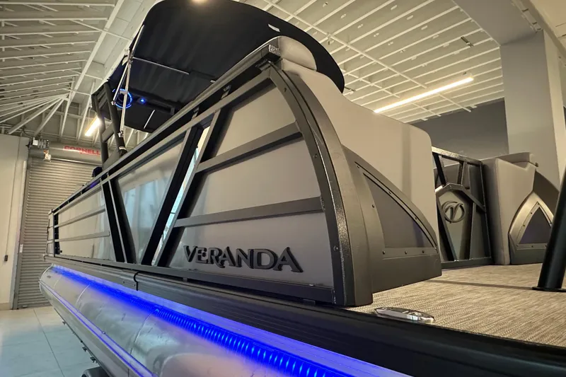 Slide: The Image of 2025 Veranda VX 27 DCRC pontoon boat with sleek design and blue LED lighting. - 11