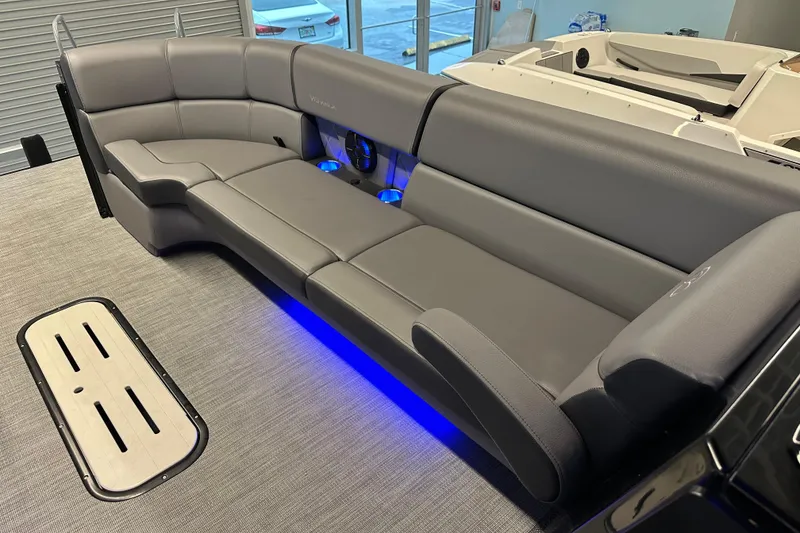 Slide: The Image of 2025 Veranda VX 27 DCRC boat interior with gray seating and blue LED lighting. - 13