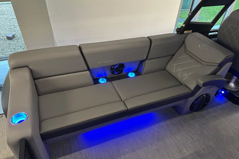 Slide: The Image of Luxurious Veranda VX 27 DCRC 2025 boat seating with blue LED lighting and sleek design. - 16