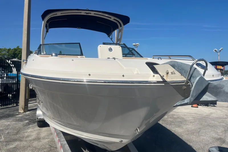 Slide: The Image of 2024 Sea Ray SDX 270 Outboard boat on trailer under clear blue sky. - 3