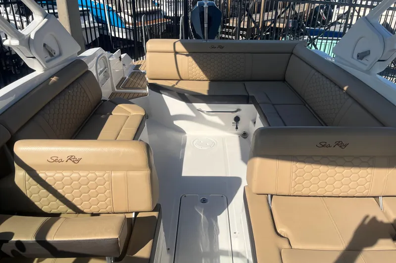 Slide: The Image of 2024 Sea Ray SDX 270 Outboard boat interior with tan leather seating and spacious layout. - 5