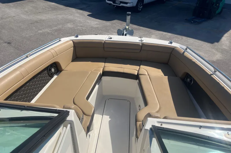 Slide: The Image of 2024 Sea Ray SDX 270 Outboard boat with tan seating and spacious deck area. - 7