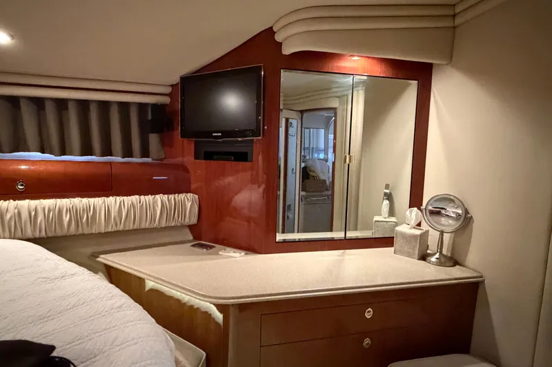 Slide: The Image of Luxurious interior of 2003 Sea Ray 560 Sedan Bridge yacht with vanity and TV. - 15