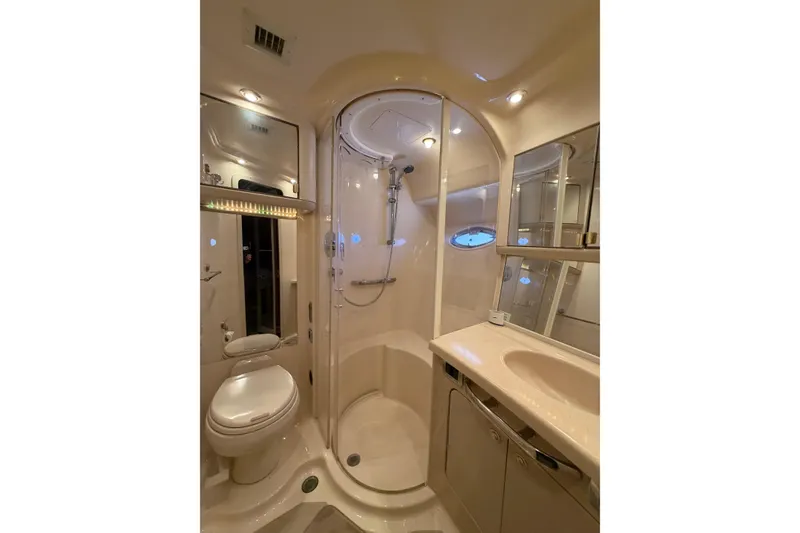 Slide: The Image of Luxurious bathroom in 2003 Sea Ray 560 Sedan Bridge yacht, featuring shower and vanity. - 16
