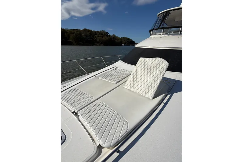 Slide: The Image of Luxurious 2003 Sea Ray 560 Sedan Bridge yacht with sunbathing deck, on serene water. - 9