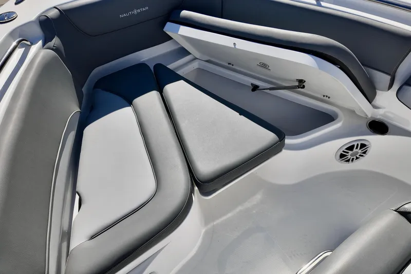 Slide: The Image of 2025 NauticStar 212 Legacy boat interior with cushioned seating and storage compartment. - 10