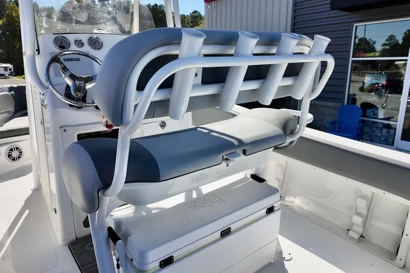 Slide: The Image of 2025 NauticStar 212 Legacy boat interior with rod holders and steering console. - 17