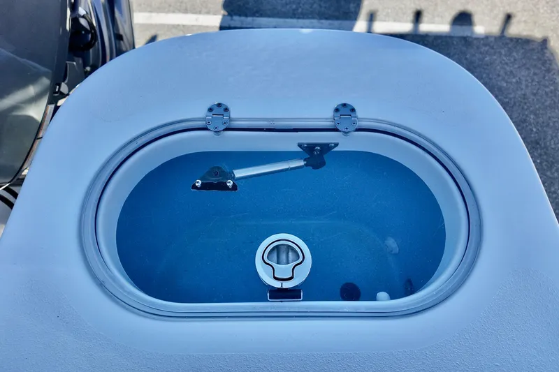 Slide: The Image of 2025 NauticStar 212 Legacy boat livewell with clear lid and latch. - 18