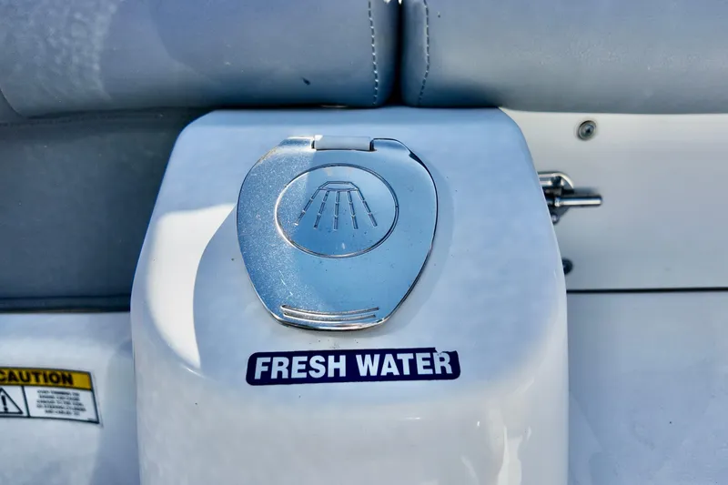 Slide: The Image of Freshwater access on 2025 NauticStar 212 Legacy boat, featuring a sleek metal cover. - 19