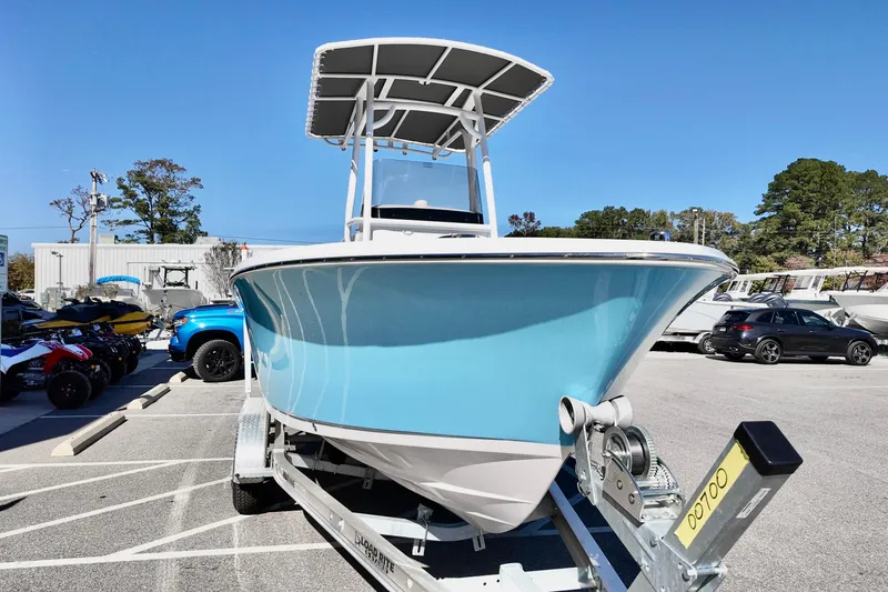 Slide: The Image of 2025 NauticStar 212 Legacy boat on trailer in parking lot. - 5
