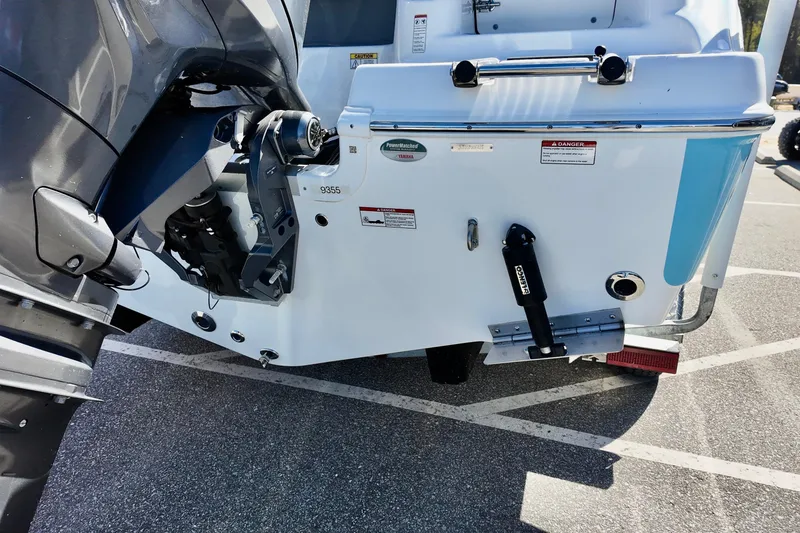 Slide: The Image of 2025 NauticStar 212 Legacy boat stern with outboard motor and trim tabs. - 8