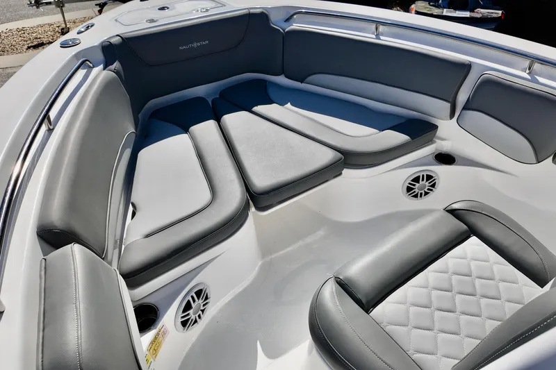 Slide: The Image of 2025 NauticStar 212 Legacy boat interior with gray cushioned seating and modern design. - 9