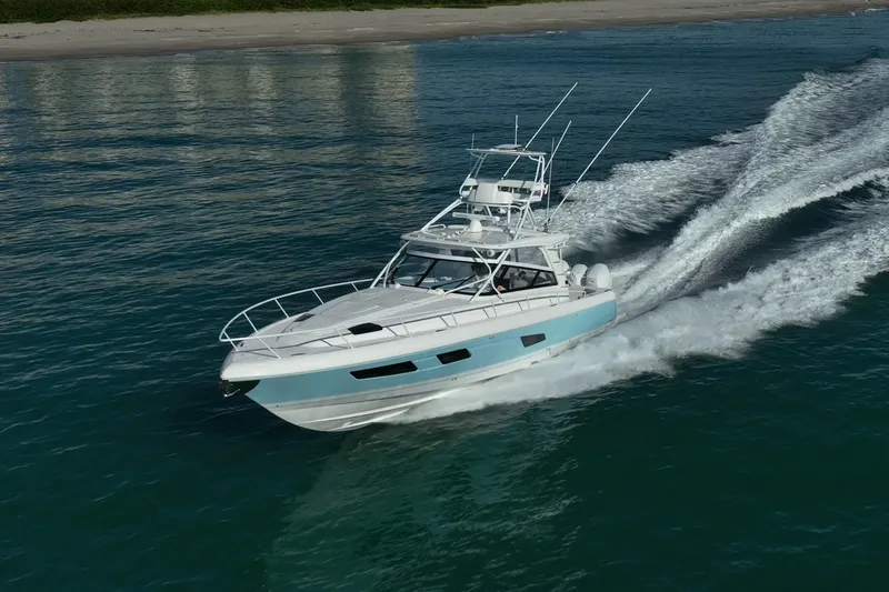 Slide: The Image of 2023 Intrepid 477 Evolution cruising on the ocean near the shoreline. - 1