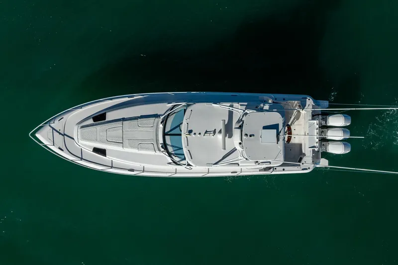 Slide: The Image of Aerial view of 2023 Intrepid 477 Evolution boat on clear water. - 12