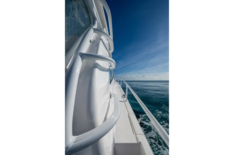 Slide: The Image of Side view of 2023 Intrepid 477 Evolution yacht cruising on open sea. - 13