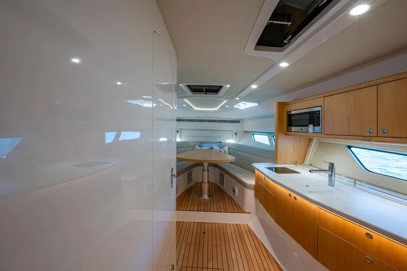 Slide: The Image of Luxurious interior of 2023 Intrepid 477 Evolution yacht with modern kitchen and seating area. - 21