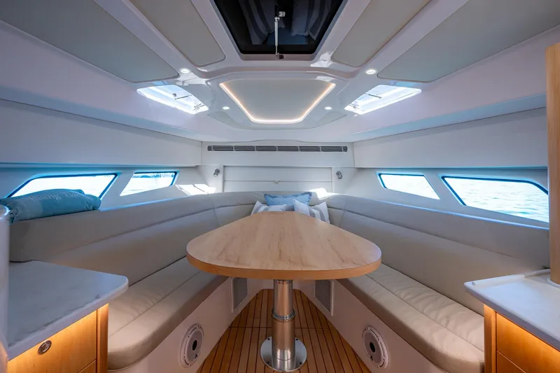 Slide: The Image of Luxurious interior of 2023 Intrepid 477 Evolution yacht with elegant seating and wooden table. - 26