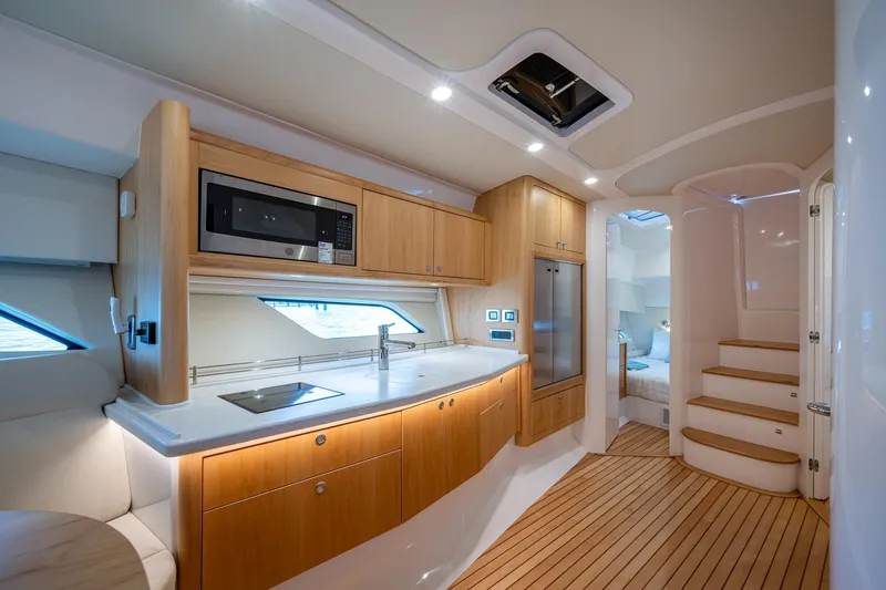 Slide: The Image of Luxurious interior of 2023 Intrepid 477 Evolution yacht with modern kitchen and cozy bedroom. - 28
