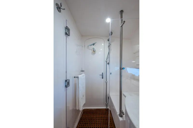 Slide: The Image of 2023 Intrepid 477 Evolution yacht bathroom with modern shower and sleek design. - 32