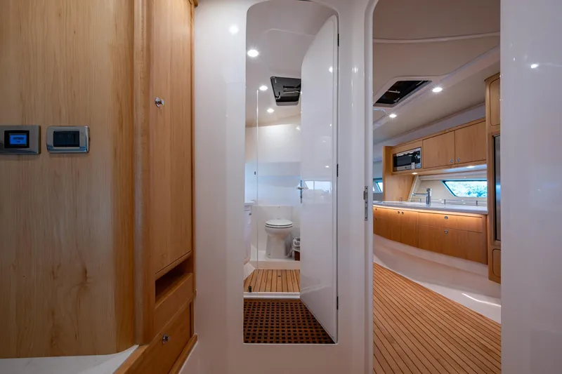 Slide: The Image of Luxurious interior of 2023 Intrepid 477 Evolution yacht, featuring modern kitchen and bathroom. - 36