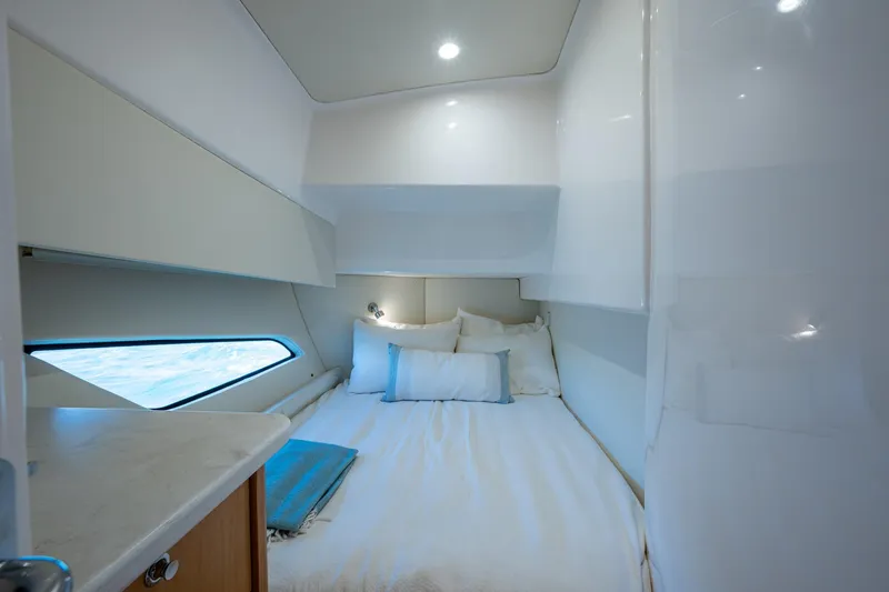 Slide: The Image of 2023 Intrepid 477 Evolution cabin interior with bed, pillows, and window view. - 39