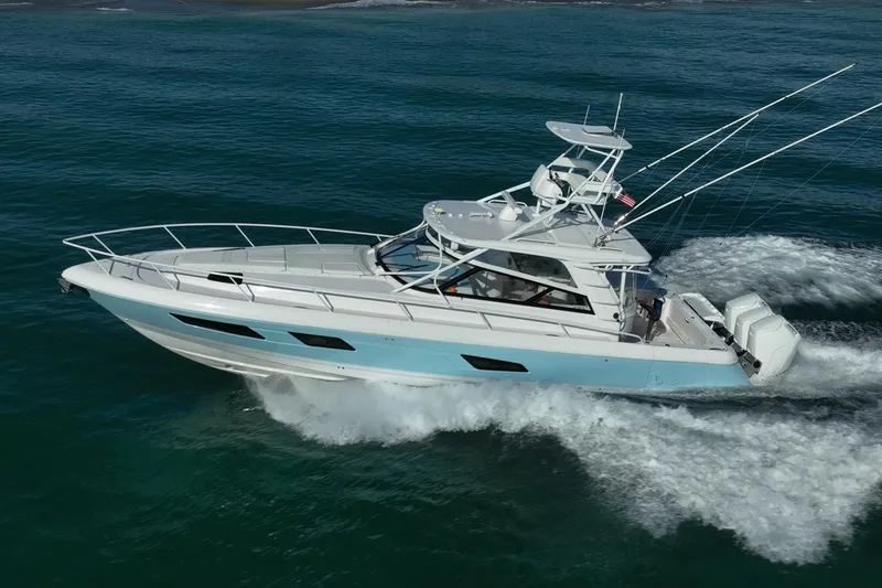 Slide: The Image of 2023 Intrepid 477 Evolution yacht cruising on open water, showcasing sleek design and powerful engines. - 4