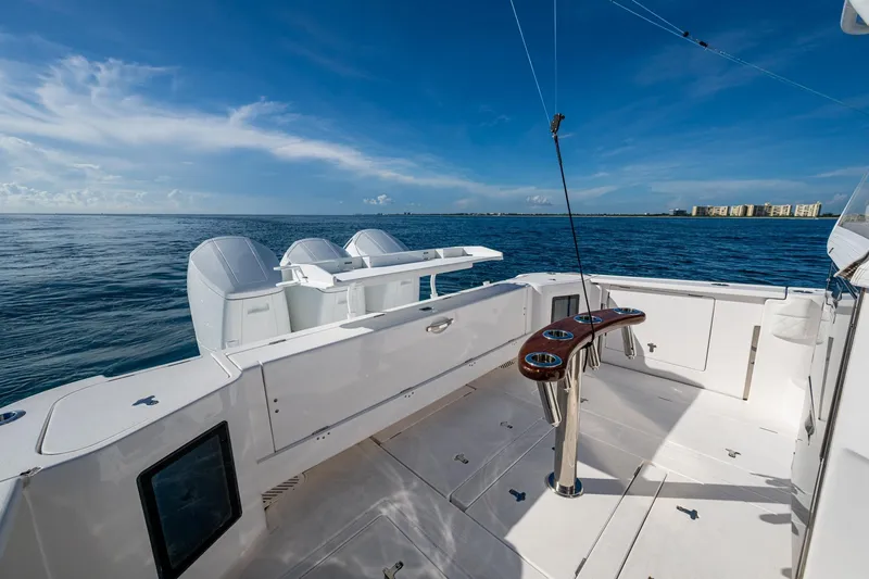 Slide: The Image of 2023 Intrepid 477 Evolution boat deck with ocean view and clear blue sky. - 42