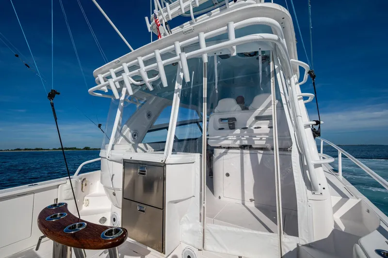 Slide: The Image of 2023 Intrepid 477 Evolution boat cockpit with fishing rod holders and ocean view. - 46