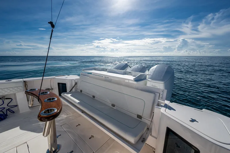 Slide: The Image of 2023 Intrepid 477 Evolution boat deck with ocean view and seating area. - 49