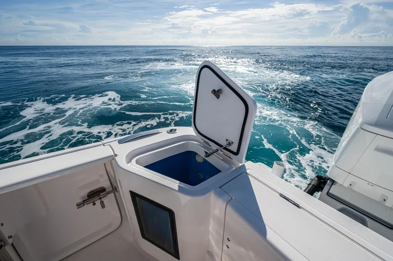 Slide: The Image of 2023 Intrepid 477 Evolution boat with open storage compartment, ocean view. - 53