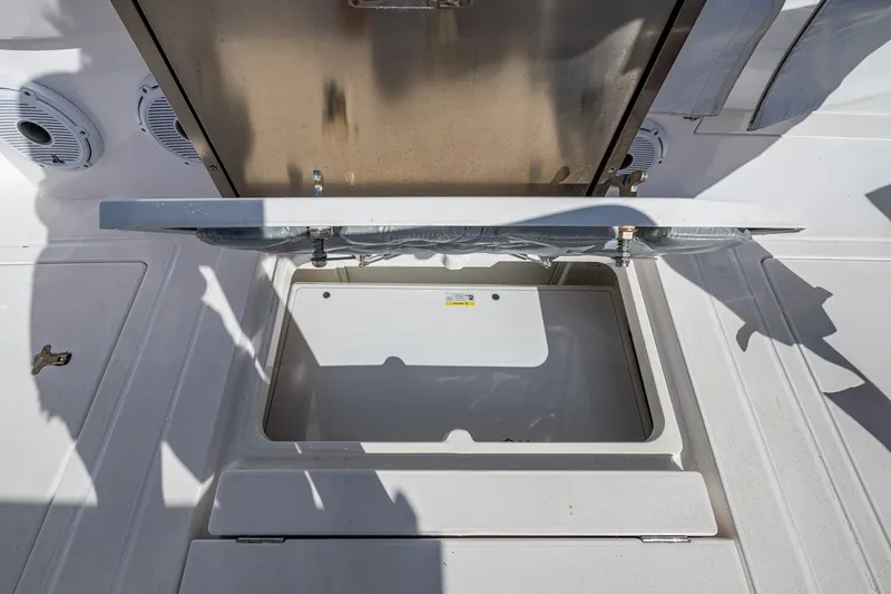 Slide: The Image of Open storage compartment on 2023 Intrepid 477 Evolution boat deck. - 56
