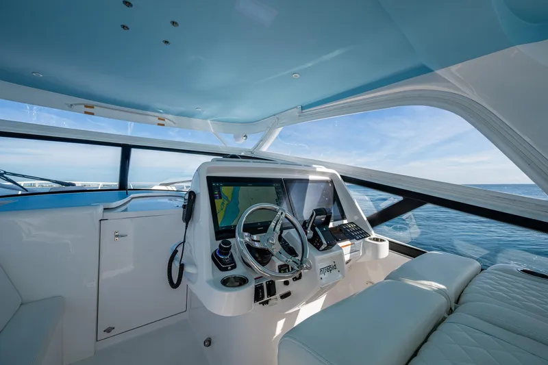 Slide: The Image of 2023 Intrepid 477 Evolution yacht cockpit with modern navigation system and ocean view. - 62