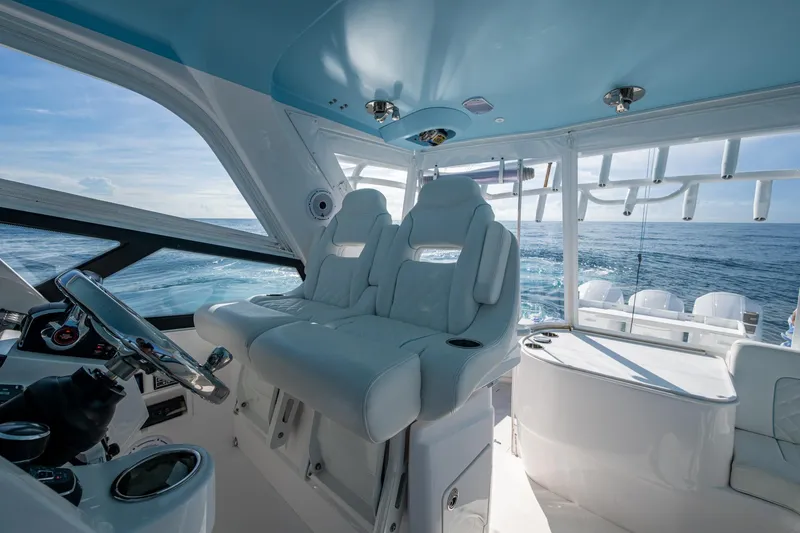 Slide: The Image of Interior of 2023 Intrepid 477 Evolution yacht with luxurious seating and ocean view. - 64