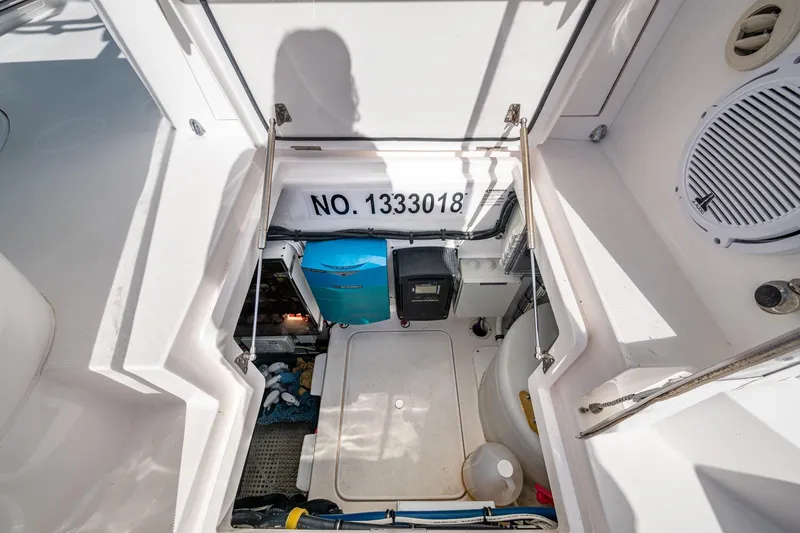 Slide: The Image of 2023 Intrepid 477 Evolution boat storage compartment with equipment and serial number. - 67