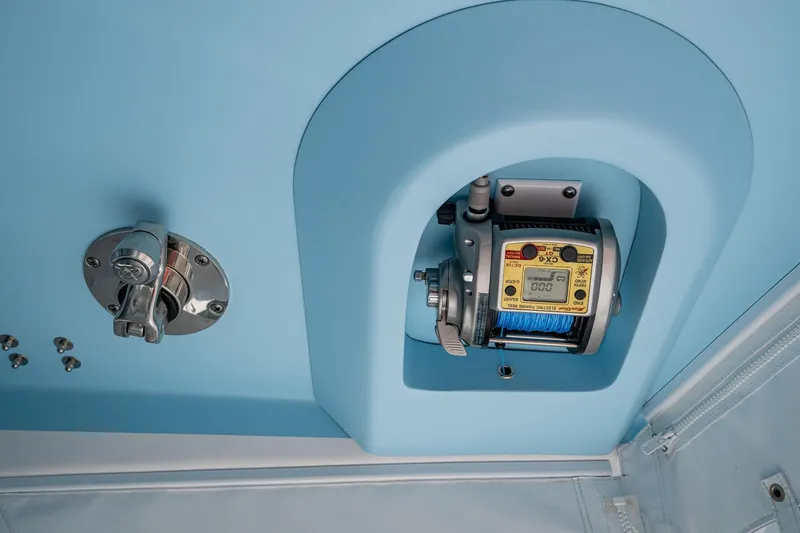 Slide: The Image of 2023 Intrepid 477 Evolution boat detail with electronic fishing reel and control panel. - 71