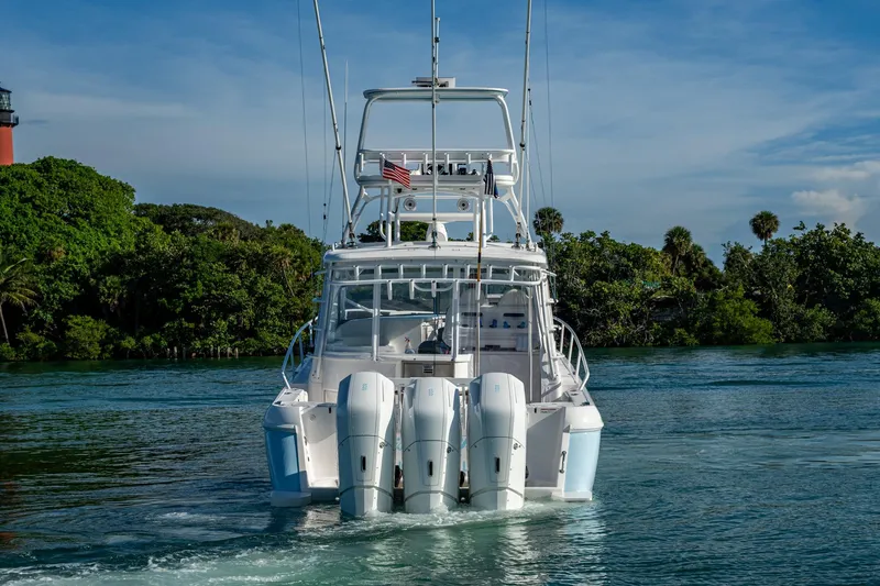 Slide: The Image of 2023 Intrepid 477 Evolution boat with triple engines on a scenic waterway. - 79