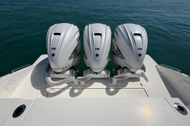 Slide: The Image of 2021 Pursuit S 378 Sport boat with triple Yamaha outboard engines on the water. - 14