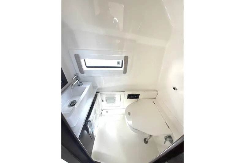 Slide: The Image of 2021 Pursuit S 378 Sport boat bathroom with sink, toilet, and window. - 16