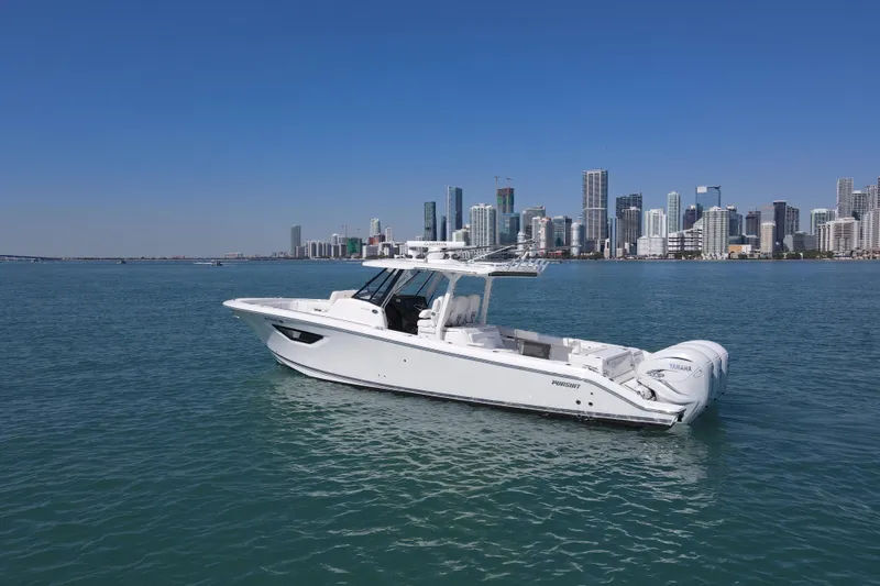 Slide: The Image of 2021 Pursuit S 378 Sport boat on water with city skyline backdrop. - 4