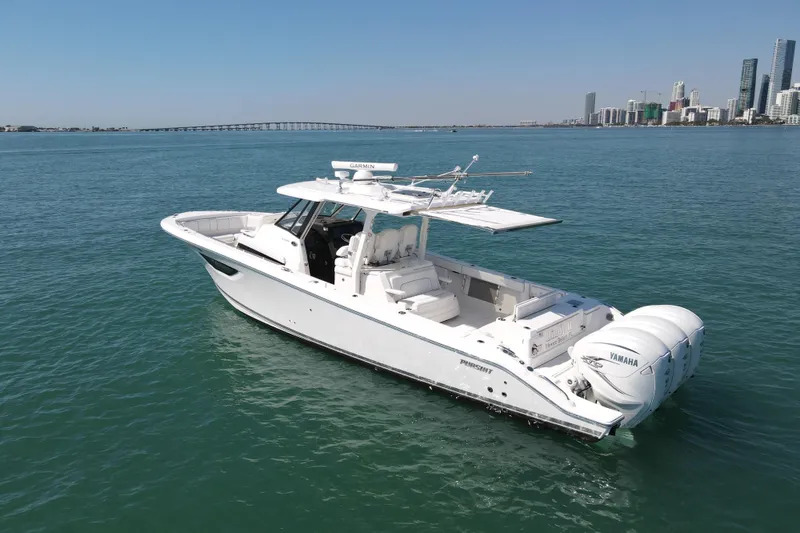 Slide: The Image of 2021 Pursuit S 378 Sport boat on calm water with city skyline background. - 5