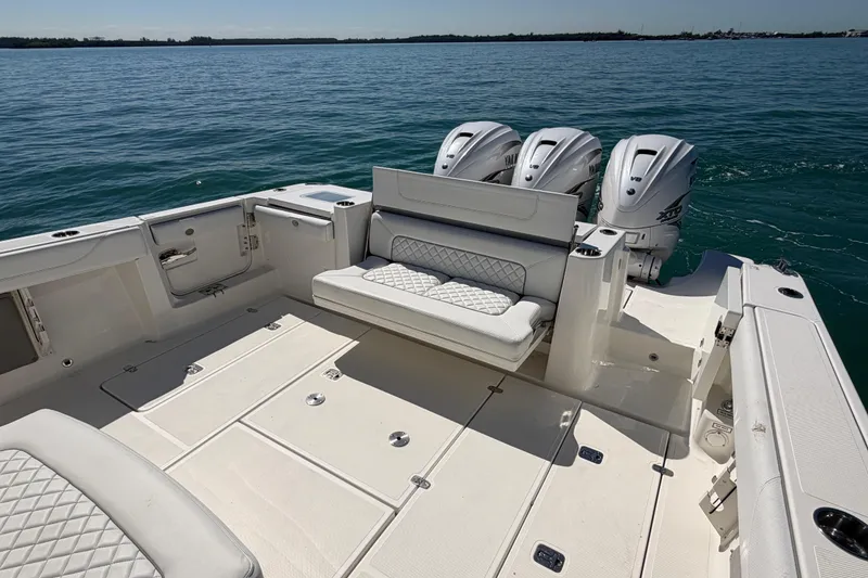 Slide: The Image of 2021 Pursuit S 378 Sport boat with triple engines on open water. - 7