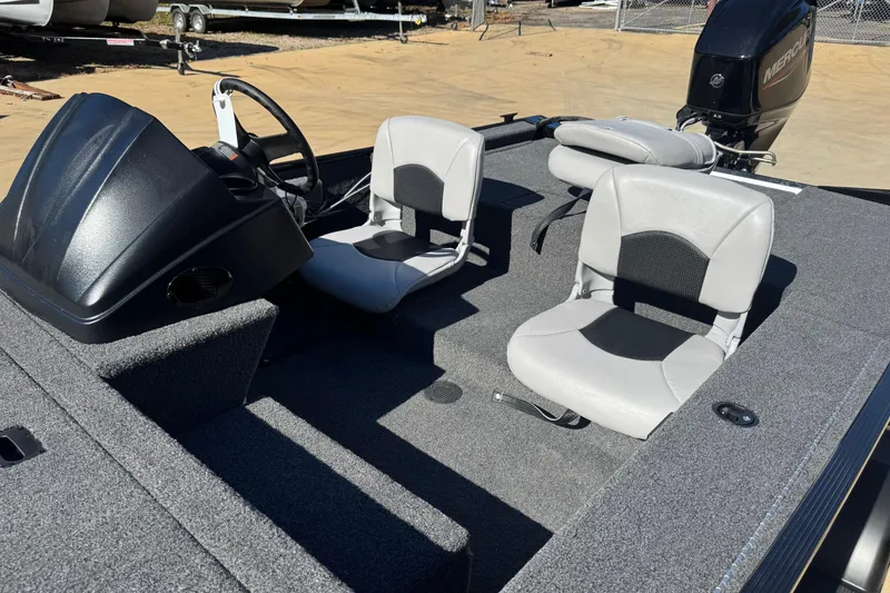 Slide: The Image of 2026 Crestliner 1600 Storm boat interior with steering console and two seats. - 3
